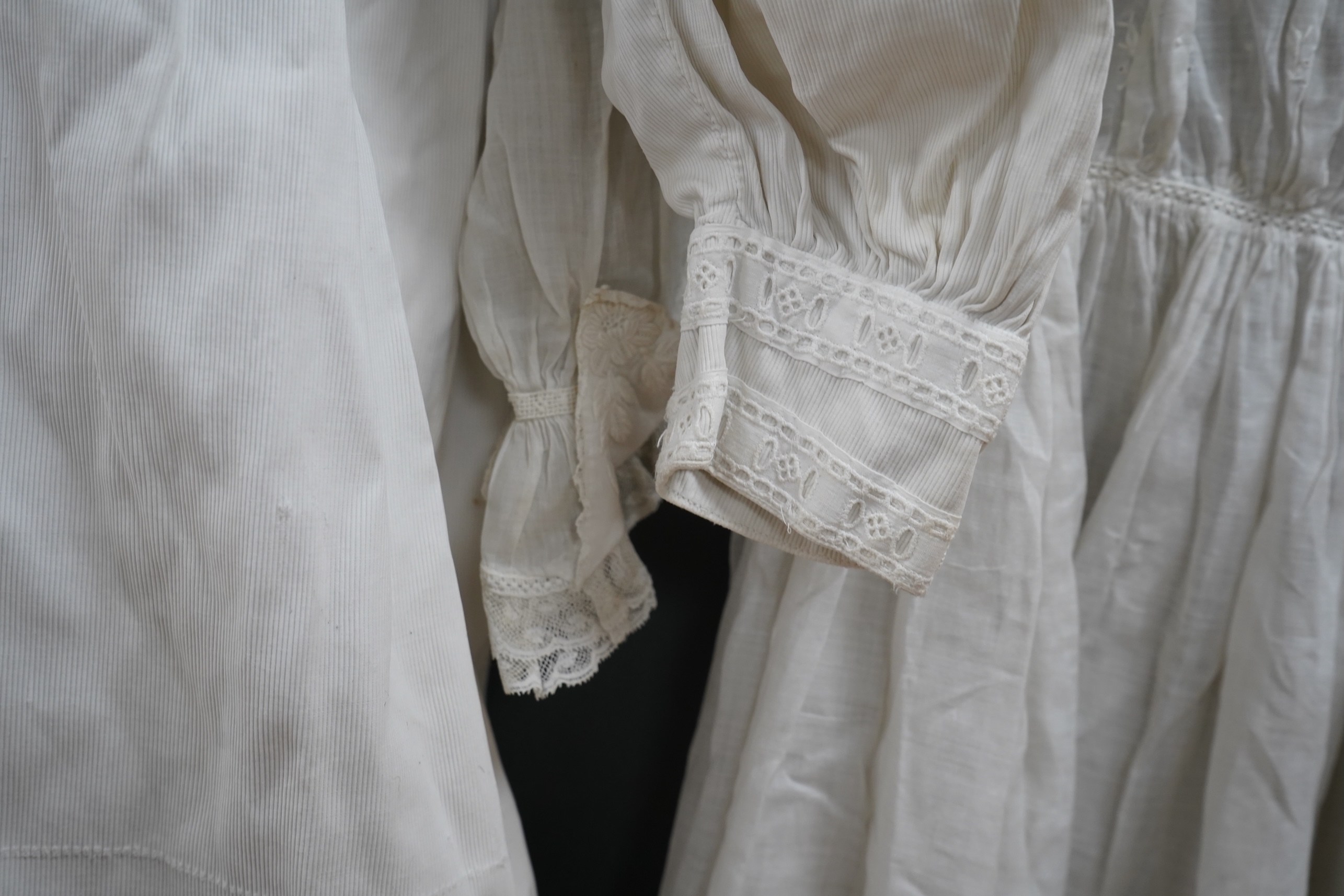 Two late 19th early 20th century girls summer dresses, one fine cotton with white worked collar cuffs and bodice, the other a cotton twill with anglaise collar large puff sleeves and gathered across the chest, lawn dress